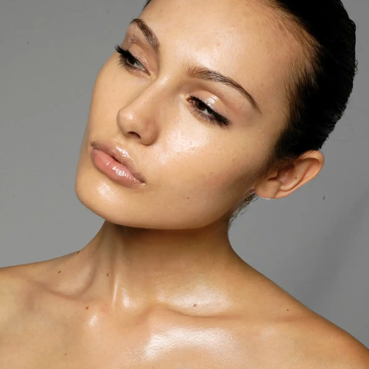 Close-up of a woman with excessively oily skin, highlighting how excess sebum causes foundation and concealer to break down. Featured on Allana Davis Studio.